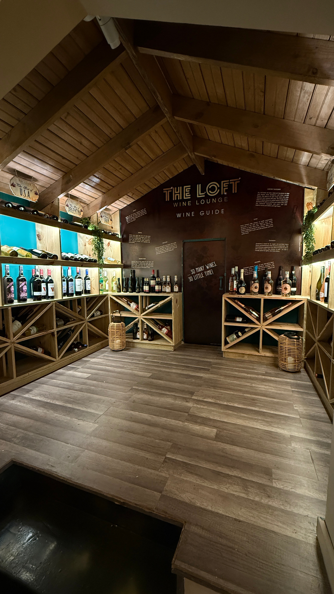 The Loft Wine Lounge wine cellar and wine guide wall